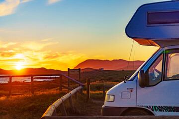 Caravan on coast at sunset