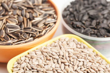 Sunflower seeds in cups on a white background