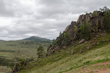 Steep rocky mountainside. View of the mountainside from the side.
