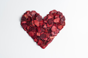 Obraz na płótnie Canvas Natural Dried Strawberry slices snack in heart shape. Dried Strawberry for baking. Dehydrated dry strawberries. Isolated white background. Love concept, valentines concept.