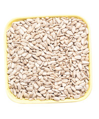 Sunflower peeled seeds in cup isolate on a white background