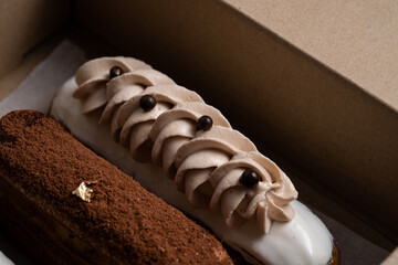 Eclair with vanilla custard filling decorated with coffee whipped creme and coffee bean