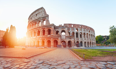 Fototapeta na wymiar Colosseum in Rome at amazing sunset or sunrise - Colosseum is the best famous known architecture and landmark in Rome, Italy