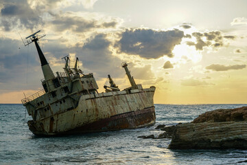 a large old rusty shipwreck on a sandbank off the coast of Cyprus