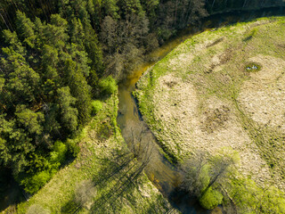 Aerial view of river valley in beautiful spring light, Czech republic, Europe. Meanders of Ploucnice river. River twists like a snake. Swirling river