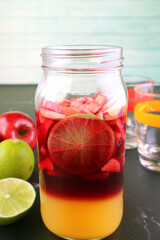 Plakat Vibrant Colors of Homemade Red Wine Sangria in a Grass Bottle before Mixing