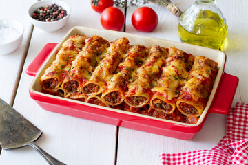 Cannelloni with meat, cheese, tomatoes and thyme. Italian cuisine.