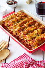 Cannelloni with meat, cheese, tomatoes and thyme. Italian cuisine.