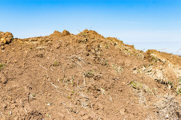 Soil on earth as texture and background. Warning or protective tape at a construction site.