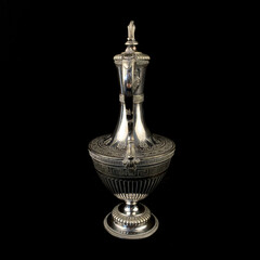 engraved antique silver decanter. vintage metal engraving with floral pattern on black isolated background