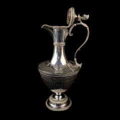 engraved antique silver decanter. vintage metal engraving with floral pattern on black isolated background