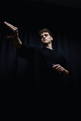 Handsome men. Barber holds in his hands a clipper and a Scissors