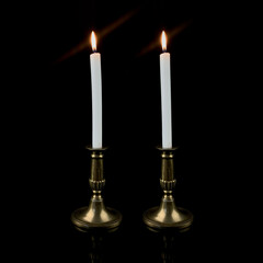 copper antique candlestick with burning candles. vintage golden candlestick on black isolated background