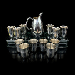 silver antique service with engraving. metal vintage hot drink service on black isolated background