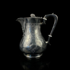 engraved antique silver decanter. vintage metal engraving with floral pattern on black isolated...