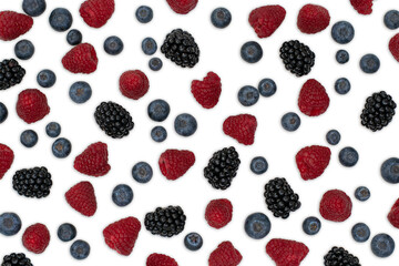 Berries pattern isolated on white. Strawberries, raspberries blackberries and blueberries arranged on white.