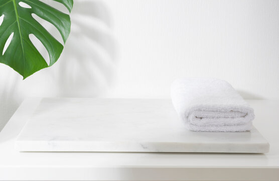 Folded Spa Towel On White Marble Podium For Product Display