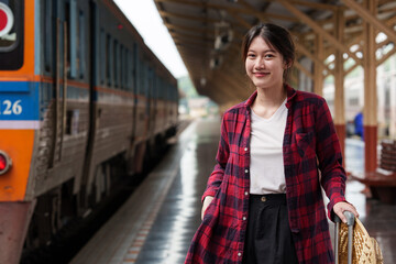 Beautiful traveler with backpack go to summer trip by train. Travel concept.