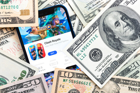 Clash Royale mobile game app. Money background. Concept, company making money with popular mobile phone games