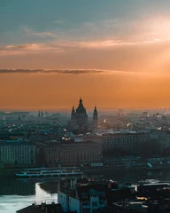 Fototapeten The city skyline of budapest during sunrise with sun beams © Ralph
