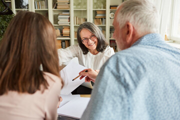 Seniors and tax consultant discuss contract