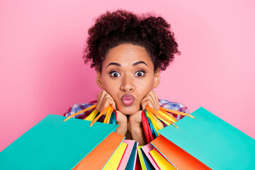 Photo of coquette curly hairdo lady hold bags blow kiss isolated on pink color background