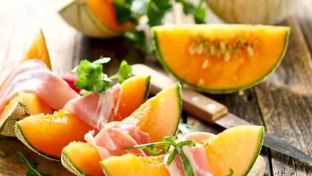 melon slices with prosciutto ham and basil