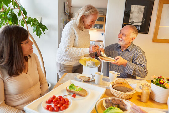 Retired seniors having breakfast in the kitchen