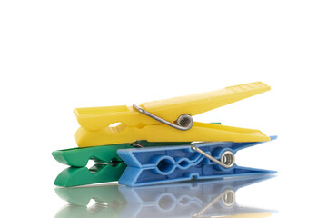 Three plastic clothespins, macro, isolated on a white background.