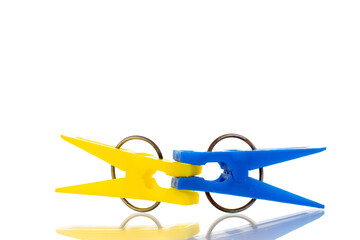 Two plastic clothespins, macro, isolated on a white background.