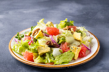 Tasty salad with grapefruit, mold cheese and walnuts