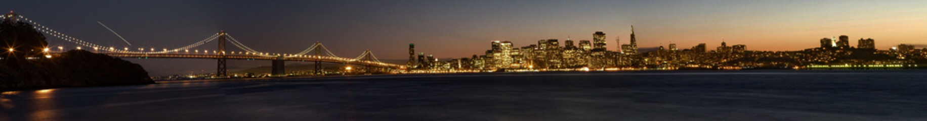 the skyline of San Francisco with the bay bridge at night