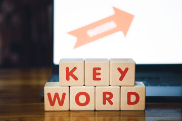 Keyword signed on a wooden cube in front of a laptop, research new ideas, finding solutions, unlocked the issue, business grow success the target, wooden Cube concept.