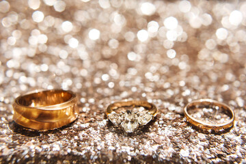 Obraz na płótnie Canvas Three wedding ring on a shiny background