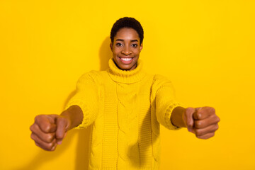 Photo of funky funny cheerful trans person driving auto training to ride wear knitted sweater isolated on yellow color background