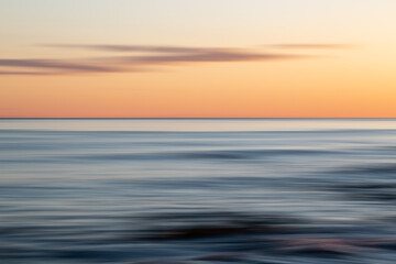 Fototapeta na wymiar An abstract coastal sunset with intentional blur