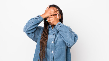 afro pretty woman covering face with both hands saying no to the camera! refusing pictures or...