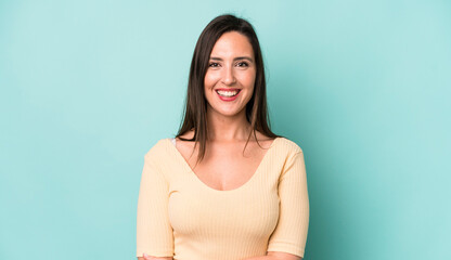young adult pretty woman laughing shyly and cheerfully, with a friendly and positive but insecure...