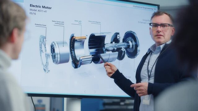 Chief Engineer Point at Projection Screen and Talks About Green Energy Electric Engine Future Possibilities. Engineering and Sustainable Energy Education Concept. Close up view