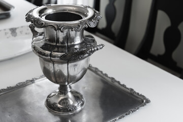 A silver vase is a tray, luxury vintage silverware