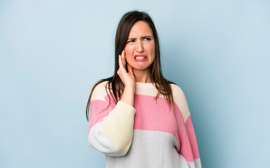 young adult pretty woman holding cheek and suffering painful toothache, feeling ill, miserable and...