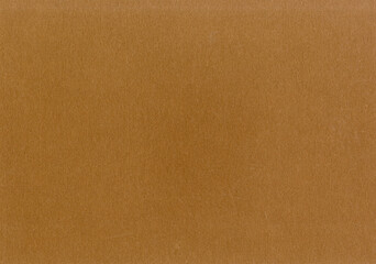 Fototapeta premium Highly detailed cardboard paper texture background fine grain caramel brown smooth uncoated corrugated fiberboard with copy space for text for material mockup or wallpaper
