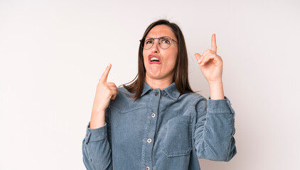 young adult pretty woman shrugging with a dumb, crazy, confused, puzzled expression, feeling...
