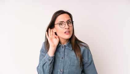 young adult pretty woman looking serious and curious, listening, trying to hear a secret...