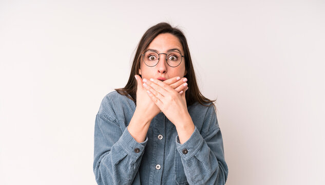young adult pretty woman covering mouth with hands with a shocked, surprised expression, keeping a secret or saying oops