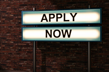 Obraz premium Illuminated light box with black letters placed in front of a brick wall. Recruitment, job interview and hiring concept. 3D illustration