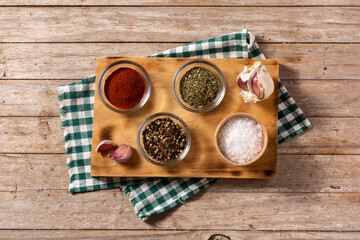 Assortment of spices on wooden cutting board. Top view