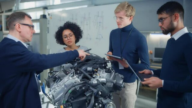 Industry High-Tech Factory: Diverse Team of Engineers Working on Engine Design Under the Supervision of Male Professor. Research, Development, Digitalisation of Green Electric Energy Concept