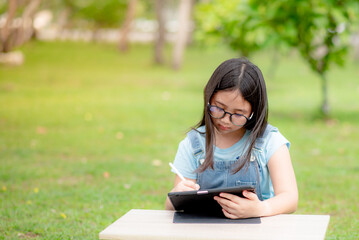 Fototapeta premium Girl studying online with tablet due to coronavirus situation