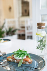 sandwich with salmon and egg po shet on a turquoise plate